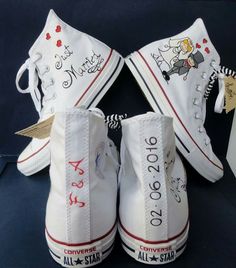 two white converse shoes with cartoon characters on them, one has a name and the other has