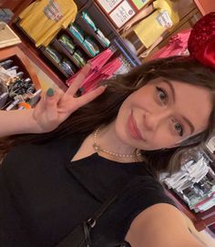 a woman with a red bow on her head posing for the camera in a store