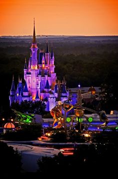 the castle is lit up at night with its lights on