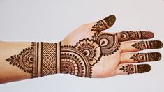 a hand with henna tattoos on it is shown in front of a white background