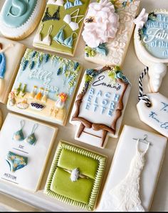 there are many decorated cookies on the table with wedding pictures and other items around them