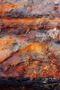 an old rusted metal surface that looks like it has been painted red and yellow