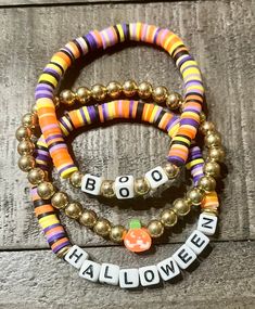 Listing includes three bracelets as shown in primary picture.   -Bracelet 1 says HALLOWEEN with multicolored Halloween theme colors -Bracelet 2 says BOO with multicolored Halloween theme colors -Bracelet 3 has gold colored beads with a Jackolantern bead in the center  Handmade with high quality elastic  These bracelets make PERFECT GIFTS for anyone special!  Sizes are estimates. Please measure your wrist and allow 1/2 inch of leeway for the correct fit. These are standard size 6.75 in to 7 in le Bracelet Sayings, Accessories For Room, Picture Bracelet, Clay Bead Bracelets, Halloween Bracelet, Trending Bracelets, Diy Bracelets Patterns, Gifts For Anyone, Bracelets Patterns