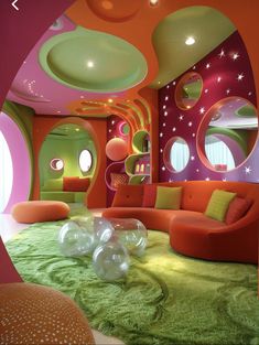 a living room filled with lots of furniture next to a green carpeted floor covered in white circles