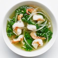 a white bowl filled with soup and shrimp