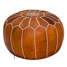 a brown leather ottoman with white stitching on the top and bottom, sitting in front of a white background