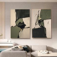 two paintings on the wall above a couch in a living room with a coffee table