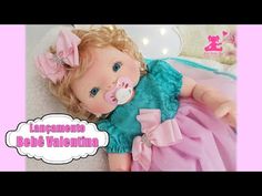 a baby doll laying on top of a bed with a pacifier in it's mouth