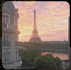 the eiffel tower is seen at sunset from across the river in paris, france