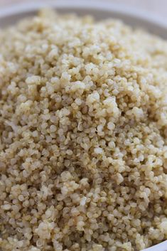 a white bowl filled with brown rice on top of a table