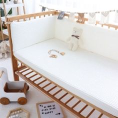 a baby crib is shown with toys on the floor