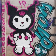 graffiti on the side of a building with a cat in it's head and letters below