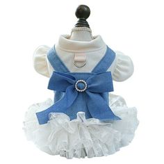 a dog wearing a blue and white dress with a bow on it's collar