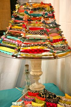 a table topped with lots of different pieces of fabric on top of a metal tray