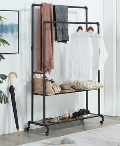 a coat rack with clothes and shoes on it