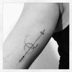 a woman's arm with an arrow tattoo on it