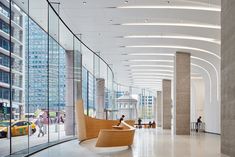 an empty lobby with people walking around the area and cars parked on the side walk