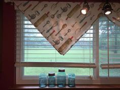 kitchen curtains with utensils on them in front of a window