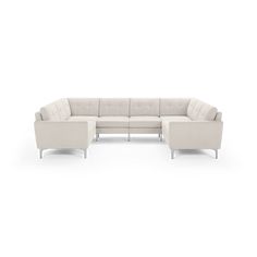 a white sectional couch sitting on top of a white floor