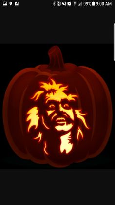 a pumpkin carved to look like the face of bob marley with flames coming out of it