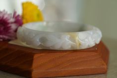 ♡This is a Natural Grade A Burmese (Myanmar) Glutinous ice Hand Carved Jadeite bangle, with a little green and yellow color(has a certification in China). ♡ Carved pattern：花開富貴，flower, leaf（meanings Bloom and prosper） ♡It's a finished product, you can get the style and color from the picture. ♡ The bangle Size: Inner diameter 58mm，Width14.4mm, thickness8.7mm. ♡Please note the original colors may be a little bit different from what you see on your monitor. ♡Postal services to certain destinations White Carved Bracelets, Leaf Meanings, White Carved Round Bracelet, Luxury Green Carved Bangle, Green Carved Bangle Bracelet, Elegant Jade Round Bangle, Luxury Carved Jade Bangle, Carved Green Jade Bangle, 100 Grade