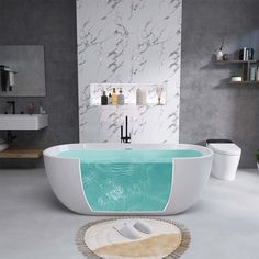 a bathroom with a white and blue bathtub next to a rug on the floor