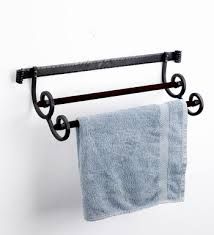 a towel rack with two towels hanging from it's sides and an iron bar attached to the wall