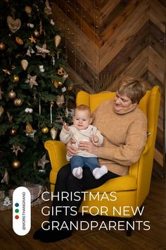 a woman sitting in a yellow chair holding a baby next to a christmas tree with the words christmas gifts for new grandparents