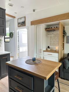 a kitchen island in the middle of a living room