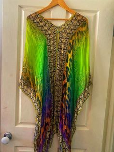 This Beautiful Embellished Kaftan Top has been well looked after and Worn once.  One size fits all  This Kaftan can be worn 2 different ways as shown in pictures  Vibrant Colours  Silky material  Perfect for the beach  Perfect Summer wear  Only 1 Available One Size Multicolor Summer Kaftan, Festive Green Kaftan For Vacation, Festive Multicolor Kaftan For The Beach, Festive Multicolor Kaftan For Beach, Embellished Multicolor Kaftan For Summer, Embellished Long Kaftan For Summer, Green Summer Party Kaftan, Summer Embellished Multicolor Kaftan, Multicolor One-size Summer Kaftan