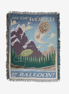 a tapestry with an image of a hot air balloon flying in the sky above mountains