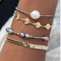 This lustrous Hiwahiwa Peacock Pearl Bead Bracelet features 14k gold filled components. We are obsessed with this moodier version of a classic white pearl bracelet. The beads vary in size, but are a fab new take on a timeless classic. You could wear this bracelet solo or pair it with other dark colored jewelry for a vibe that would make Wednesday proud. You could also pair it with other gold pieces to touch on those accents and really draw attention to the details. The styling options are numero Summer Wrist, Pearl Bead Bracelet, Colored Jewelry, Peacock Pearl, White Pearl Bracelet, Dope Jewelry, Jewelry Inspo, Summer Accessories, Summer Jewelry