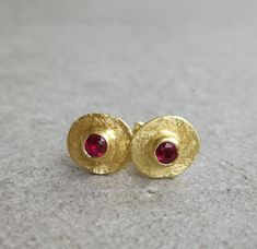 Vintage style gold earrings with tiny red Ruby 14K Gold earrings Yellow gold  Gold dainty earrings Gold stud earrings Everyday earrings Small gold stud earrings with red ruby. This is the perfect everyday earrings, it features a small raw gold disc and a small ruby stone. An excellent choice for anniversary gift or birthday gift for her. ★DETAILS: *Material you can choose: 14k, 9k solid gold. *Red Ruby: 3mm *Disk diameter approx. 8 mm *Butterfly backs included. *Matte finish. ★All my products are handmade and designed by me. *All jewelry comes in a nice package and ready to give as gift. *For any questions, custom order & special requests, please feel free to contact with me. For more earrings: https://www.etsy.com/shop/Arju?ref=seller-platform-mcnav§ion_id=7959855 Yellow Gold Ruby Earrings For Gift, Ruby Earrings In Yellow Gold For Gift, Ruby Yellow Gold Earrings For Gift, Gold Earrings With Ruby Birthstone, Gold Ruby Earrings With Birthstone, Dainty Red 14k Gold Earrings, Delicate Layered Necklace, Raw Gold, Dainty Gold Earrings