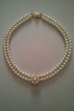 three strand pearl necklace with an 18k yellow gold clasp and diamond clasp, circa 1950's