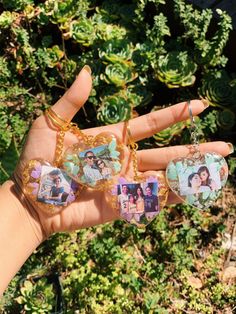 a person holding three different pictures in their hand and wearing them as necklaces or earrings