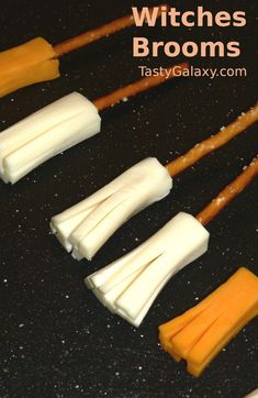 four different types of cheese sticks on a black surface with the words witches brooms