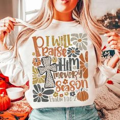 a woman wearing a t - shirt that says i will praise him through the season