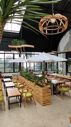 an outdoor dining area with tables and umbrellas