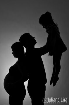 a black and white photo of a man holding a child