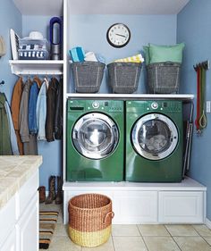 a green washer and dryer sitting in a laundry room next to each other