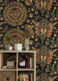 a book shelf with a vase on top of it next to a black wallpaper