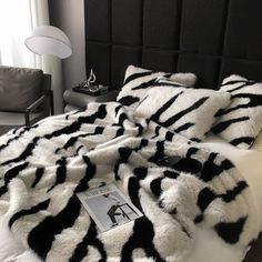 a bed with black and white fur on it