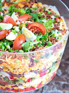 chicken bacon ranch layer salad in a glass bowl on a table with text overlay