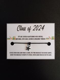 a class of 202 bracelet with a star charm on it's end and an arrow in the middle