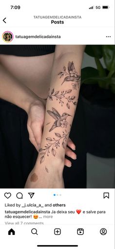 a woman's arm with flowers and birds on it