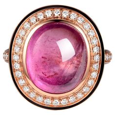 This striking ring features a captivating 7.55-carat cabochon pink tourmaline, set in a luxurious setting that showcases the gemstone's rich, saturated color and unique, smooth dome shape. The tourmaline is nestled within a halo of sparkling diamonds that total 0.41 carats, adding a touch of brilliance around the soft pink hue. A delicate black enamel detailing borders the diamonds, creating an elegant contrast that highlights the vibrancy of the tourmaline. This piece is crafted to a size 6.5, Luxury Pink Oval Cabochon Rings, Enamel Ring, Pink Ring, Saturated Color, Sparkle Diamonds, Cluster Ring, Black Enamel, Pink Tourmaline, Soft Pink