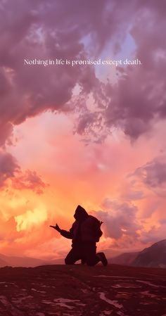 the silhouette of a person walking across a field under a cloudy sky with an orange and pink sunset in the background