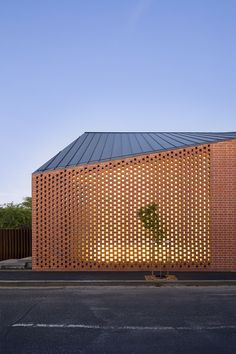 a brick building with a tree in the middle