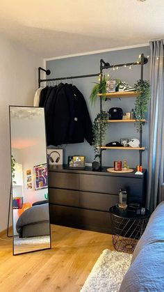 a bedroom with a bed, mirror and shelves on the wall in front of it