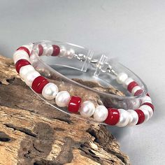 This beautiful bracelet is made from white genuine freshwater pearls and red-colored natural collar beads. These minerals are very well combined. Bracelet for men and women. June birthday gift. Sterling silver lobster lock. Details: * White pearl 4.4 mm/0.18'' * Red coral beads 3.4 mm/0.16'' * 925 sterling silver lobster clasp * 925 sterling silver jewelry accessories This is a handmade item. 100% repetition is impossible due to the individuality of the composition of the natural material. When Red Pearl Bracelets With Round Beads, Red Pearl Bracelets For Gifts, Red Pearl Bracelets As A Gift, Red Pearl Bracelet As A Gift, Red Pearl Bracelet As Gift, Red Pearl Bracelets For Gift, Red Pearl Bracelet Gift, Real Pearl Bracelet, Red Coral Jewellery